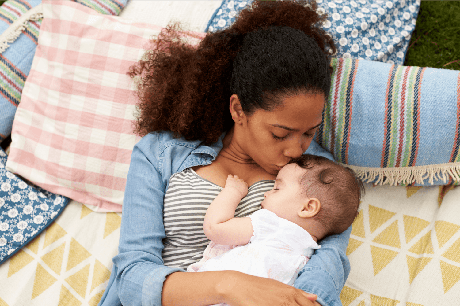 Background. Pregnant woman laying an ice pack on her stomach.