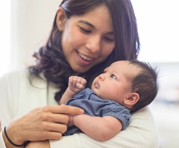 A mother holding her baby