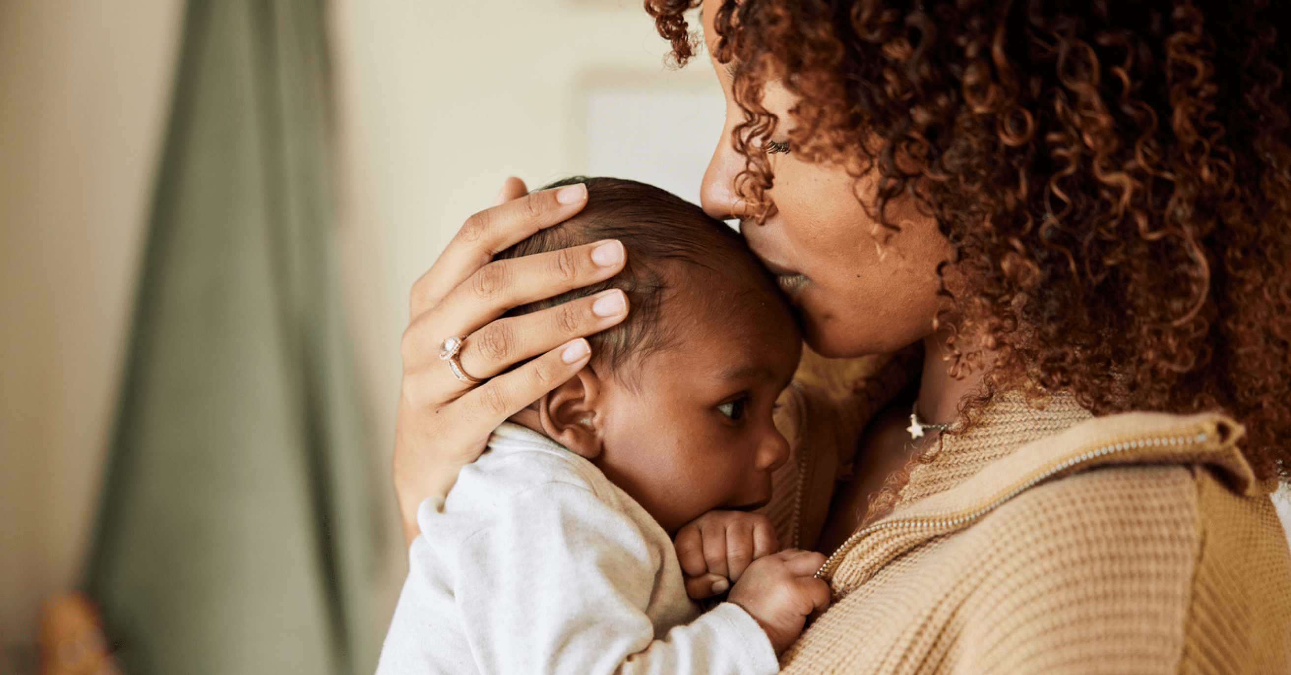 Mother kissing child on the head.